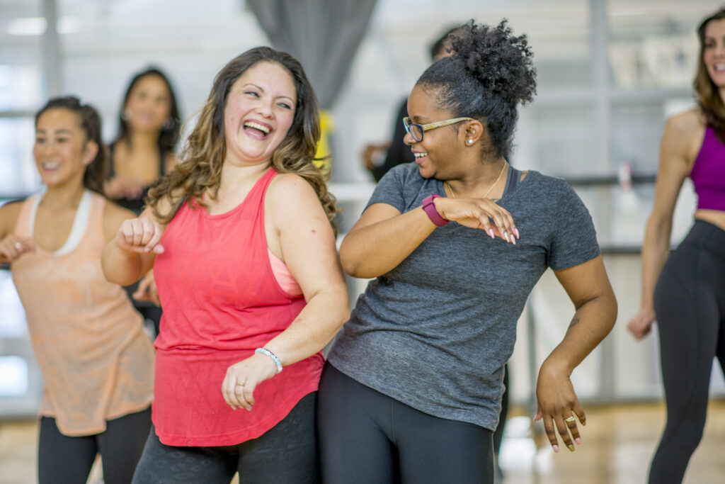 Group of women dancing in a group exercise class.