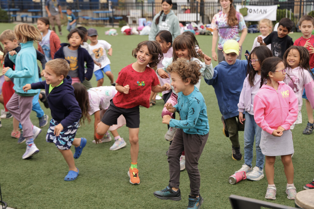 May contain many people playing on a grassy field.