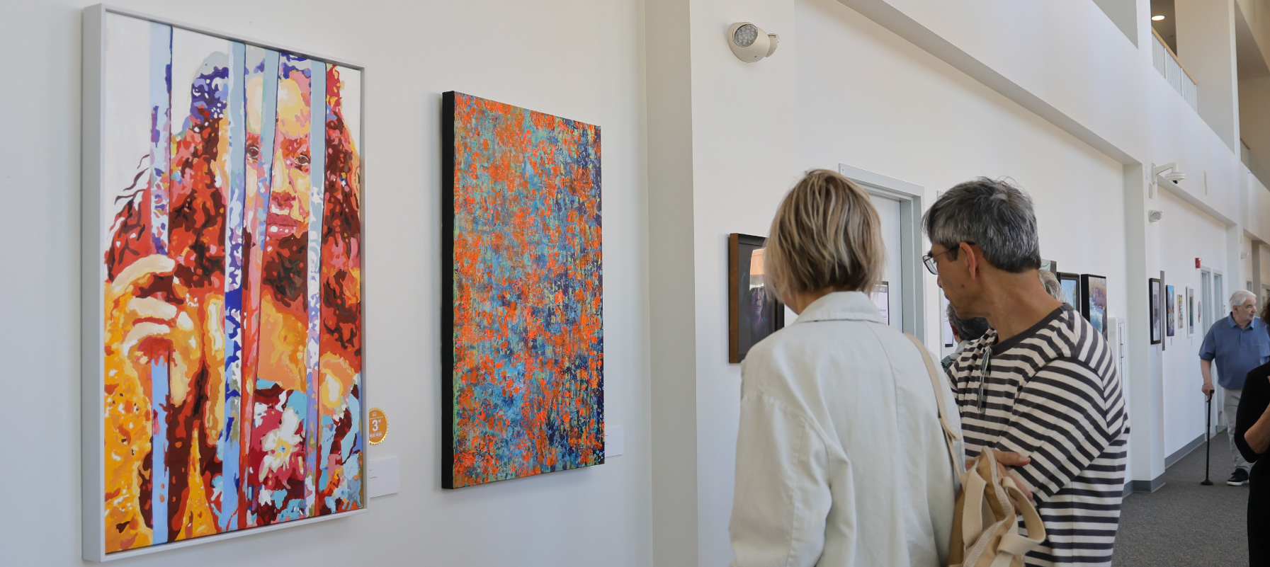 May contain multiple people viewing art.