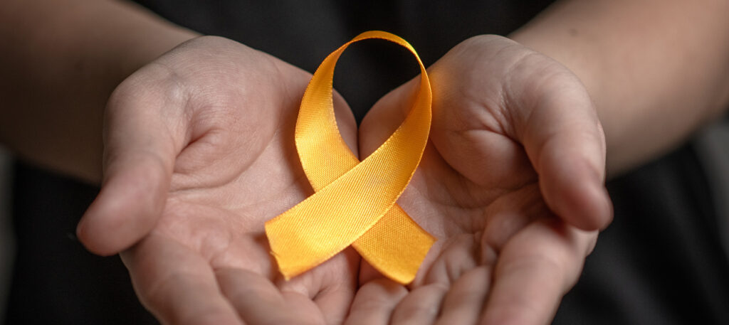 May contain a person holding a yellow ribbon.