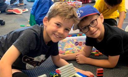 May contain two people playing with LEGO bricks.