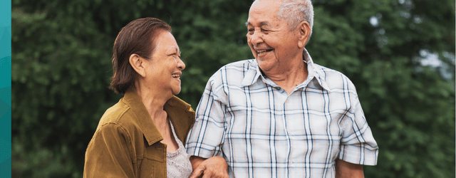 Woman and man walking arm in arm, laughing together